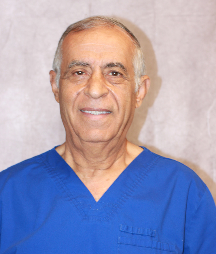 Mo, smiling, in blue scrubs